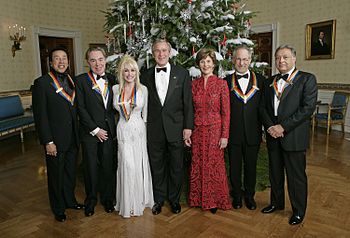 U.S. President George W. Bush and First Lady Laura Bush, with the Kennedy Center honorees in the Blue Room of the White House during a 2006 reception. From left: singer/songwriter William "Smokey" Robinson; composer Andrew Lloyd Webber; Dolly Parton; film director Steven Spielberg; and conductor Zubin Mehta.