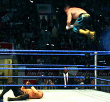Guerrero giving a Frog splash during his tag team match with Rey Mysterio against the Basham Brothers during a WWE house show held in Kitchener, Ontario, Canada on January 15, 2005