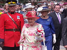 Elizabeth II (centre, in pink) during a walkabout in Queen's Park, Toronto, 6 July 2010