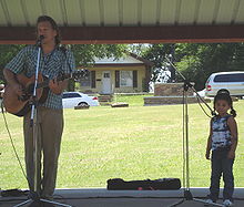 Paul is joined on stage by a young fan while performing at the Children's Festival at the 2008 Woody Guthrie Folk Festival - July 12, 2008.