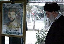 Khamenei standing beside the tomb of General Ali Sayyad Shirazi, Chief of the Ground Forces of The Army of Iran during the Iran-Iraq war