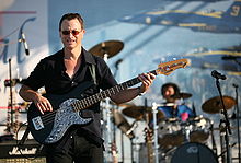 Sinise playing bass guitar in the Lt. Dan Band.