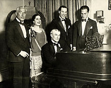 Birthday party honoring Maurice Ravel in New York City, March 8, 1928. From left: Oskar Fried; Éva Gauthier; Ravel at piano; Manoah Leide-Tedesco; and George Gershwin.