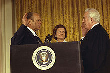 Gerald Ford is sworn in as the 38th President of the United States by Chief Justice Warren Burger in the White House East Room, while Betty Ford looks on