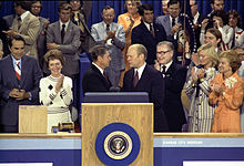 Governor Ronald Reagan congratulates President Ford after the president successfully wins the 1976 Republican nomination, while Bob Dole, Nancy Reagan, and Nelson Rockefeller look on.