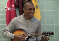 Gilberto playing a mandolin