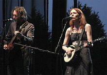 Gillian Welch playing banjo in a performance with David Rawlings