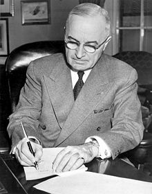 President Truman signing a proclamation declaring a national emergency that initiated U.S. involvement in the Korean War