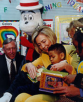 Clinton reads to a child during a school visit