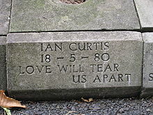 Curtis' gravesite where the replacement of the stolen headstone still carries the inscription, Love will tear us apart.
