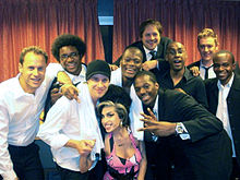 Amy Winehouse with her band backstage, 16 March 2009