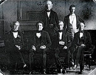 Polk and his cabinet in the White House dining room. Front row, left to right: John Y. Mason, William L. Marcy, James K. Polk, Robert J. Walker Back row, left to right: Cave Johnson, George Bancroft Secretary of State James Buchanan is absent.
