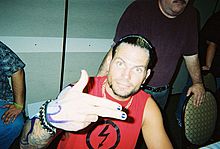 Hardy at an autograph signing, showing his roots tattoo on his arm