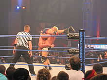 Jarrett performing a tombstone piledriver on Kurt Angle