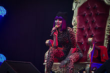 Jessie J performing at the 2011 The Big Chill, sitting on the "gilded throne" she used for performances while her foot was broken.