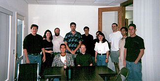 The staff of Wales' internet company Bomis photographed in Summer 2000. Wales is third from the left in the back row, with his then-wife Christine