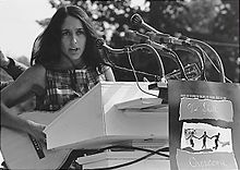 Baez playing at the March on Washington in August 1963.