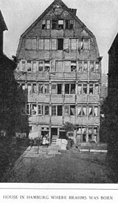 Photograph from 1891 of the building in Hamburg where Brahms was born. Brahms's family occupied part of the first floor, behind the two double windows on the left hand side. The building was destroyed by bombing in 1943.