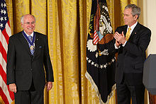 Howard (left) being awarded the Presidential Medal of Freedom by President George W. Bush