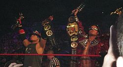 Morrison (right), with The Miz (left) as World Tag Team Champions and with their Slammy Awards.