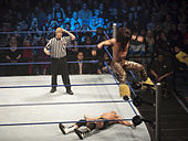 Morrison performing Starship Pain, a split-legged corkscrew moonsault.