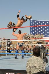 Morrison performing a Diving crossbody on The Miz at WWE Tribute to the Troops.