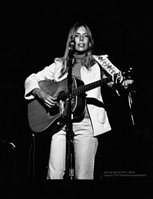 Mitchell performing in concert at the Universal Amphitheatre in August 1974