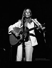 Mitchell performing in concert at the Universal Amphitheatre in August 1974