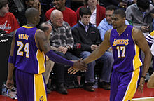Bynum slaps hands with Kobe Bryant.