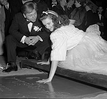 Rooney watches Garland put her handprint into cement at Grauman's Chinese Theatre, 1939.