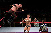 Kane performing a flying clothesline on CM Punk.
