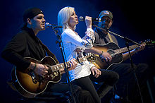 Kellie Pickler and members of her band Ryan Ochsner, left, and Joshua Henson perform for U.S. service members during the first stop of the 2008 USO Holiday Tour on Ramstein Air Force Base, Germany, Dec. 16, 2008