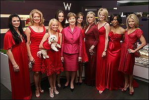 Chenoweth (holding her dog, Madeline Kahn "Maddie" Chenoweth) joins Laura Bush and celebrity models in 2007 to raise awareness of heart disease in the Red Dress Collection Celebrity Fashion Show