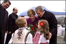 Romanian children greet President and Mrs. Bush upon their landing in Bucharest, 2002