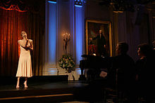 President George W. Bush and Laura Bush listen to LeAnn Rimes perform in the East Room of the White House in a performance honoring the Dance Theatre of Harlem on February 6, 2006