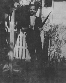 Image CE-133A, one of three known "backyard photos," the same image sent by Oswald (as a first-generation copy) to George de Mohrenschildt in April, 1963, dated and signed on the back. Oswald holds a Carcano rifle, with markings matching those on the rifle found in the Book Depository after the assassination.