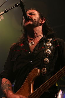 Lemmy in his usual singing stance, with his microphone in its high position.