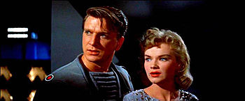 Nielsen, along with co-star Anne Francis, in his second film, Forbidden Planet (1956). Nielsen: "Supposedly a science fiction version of Shakespeare's The Tempest, it was all about the id, or something like that. Who knows? The Trekkies today regard it as the forerunner of Star Trek. I just had to wear a tight uniform and make eyes at Anne Francis. I was pretty thin back then."[28]