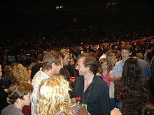 Neeson talking to Ralph Fiennes at the Madison Square Garden U2 concert, 1 October 2005