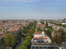 The Secret Annexe with its light-coloured walls and orange roof (bottom) and the Anne Frank tree in the garden behind the house (bottom right), seen from the Westerkerk in 2004