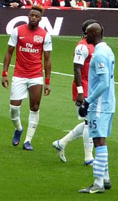 Balotelli (right) with Alex Song and Bacary Sagna in April 2012.