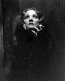 A still from Shanghai Express (1932). Josef von Sternberg used butterfly lighting to enhance Dietrich's features. This photograph was cited by Mick Rock as the inspiration for the iconic Queen II album cover.
