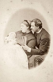 As an infant with her parents