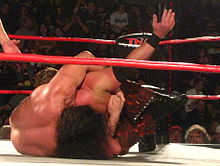 Hardy performing the Ice Pick on A.J. Styles in 2011.