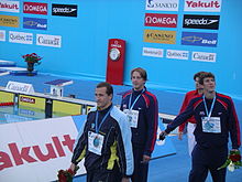 Victory lap of the 100 m butterfly during the 2005 FINA World Championships in Montréal. Phelps is far right.