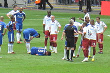 Ballack on the ground with the ankle injury in the 2010 FA Cup Final that eventually ruled him out of the World Cup after a tackle from Boateng (23).