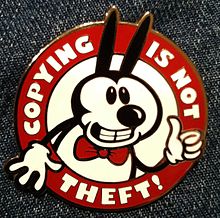 "Copying is not theft!" badge with a character resembling Mickey Mouse is a visual pun on Mickey as a symbol of the whole IP industry and its attitude towards copying.