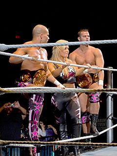 Natalya (center) with the other members of The Hart Dynasty, Tyson Kidd (left) and David Hart Smith.
