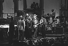 The Last Waltz, Young (center on left microphone) performing with Bob Dylan and The Band, among others in 1976.