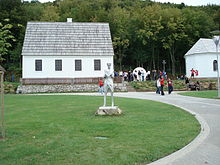 Rebuilt [14], Tesla's rebuilt house (parish hall) in Smiljan, where he was born, and the rebuilt church, where his father served. Both the house and church were burnt down during the Yugoslav Wars. The Croatian Government has rebuilt both.